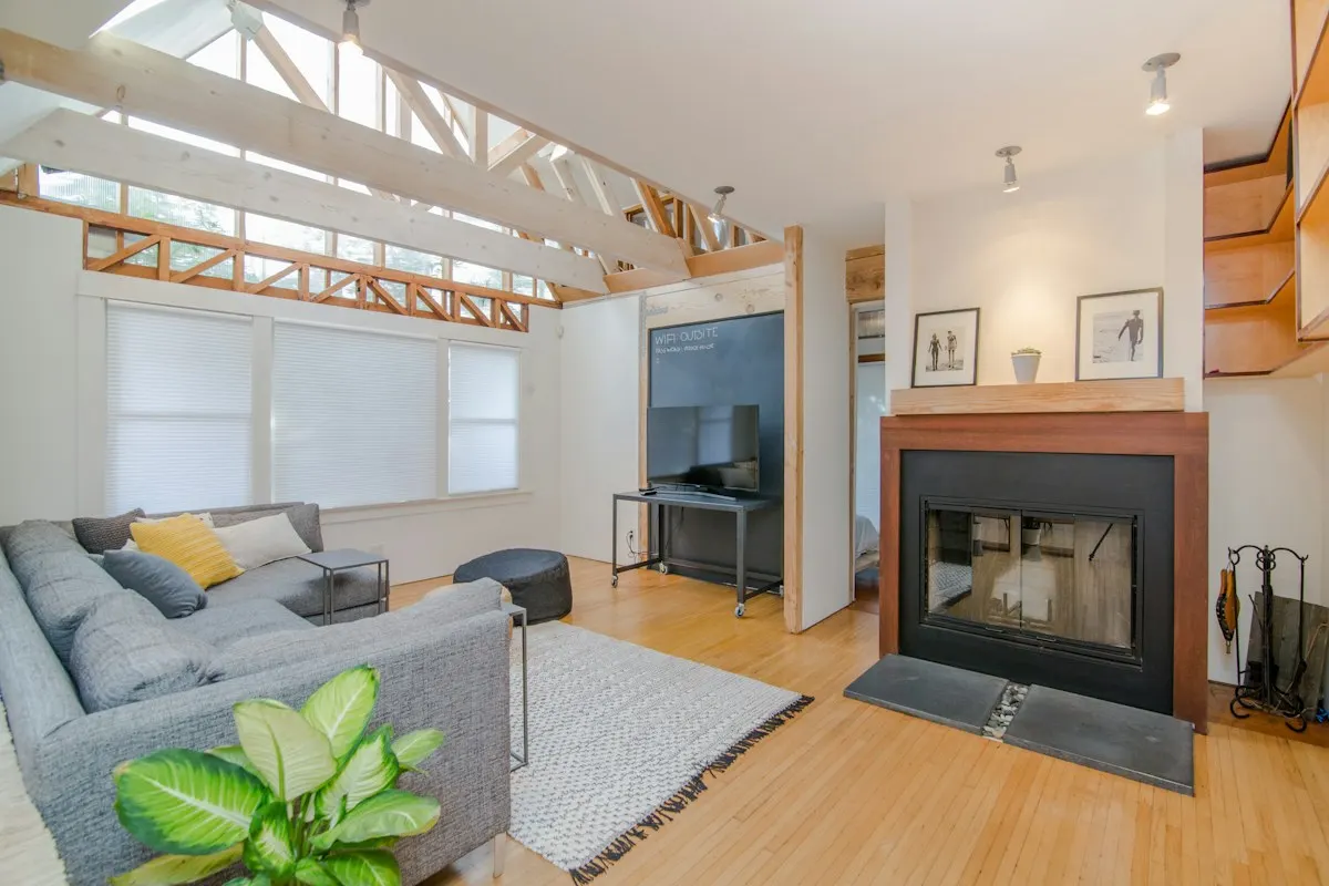 Living room with exposed beams and high windows